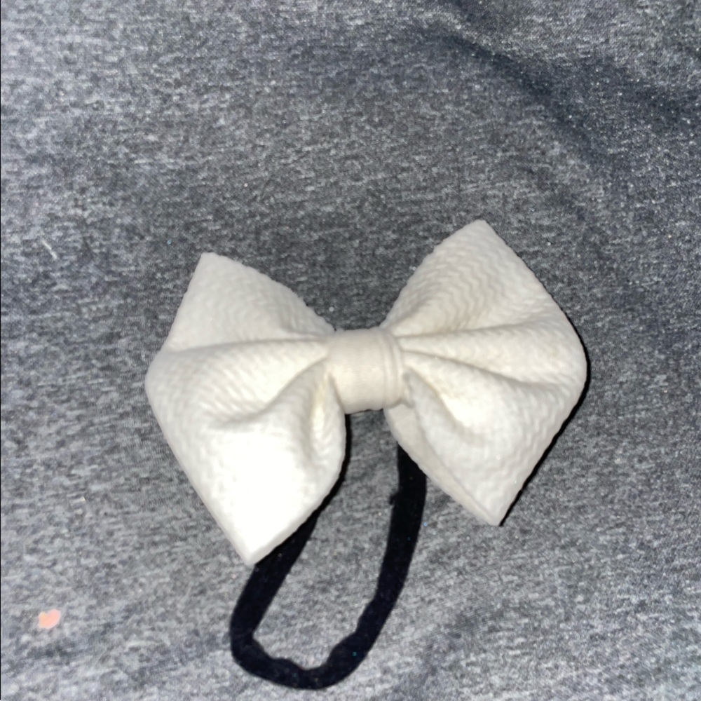 White bow on small black elastic